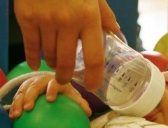 A woman uses a baby bottle to feed her newborn son. (Photo:AFP)